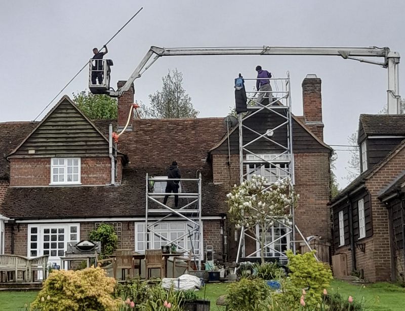The Moss Cleaners using cherry picker and scaffolding to clean roof safely and professionally in 38 Cross Rd, Tadworth KT20 5ST, UK, 38 Cross Rd, Tadworth KT20 5ST, UK